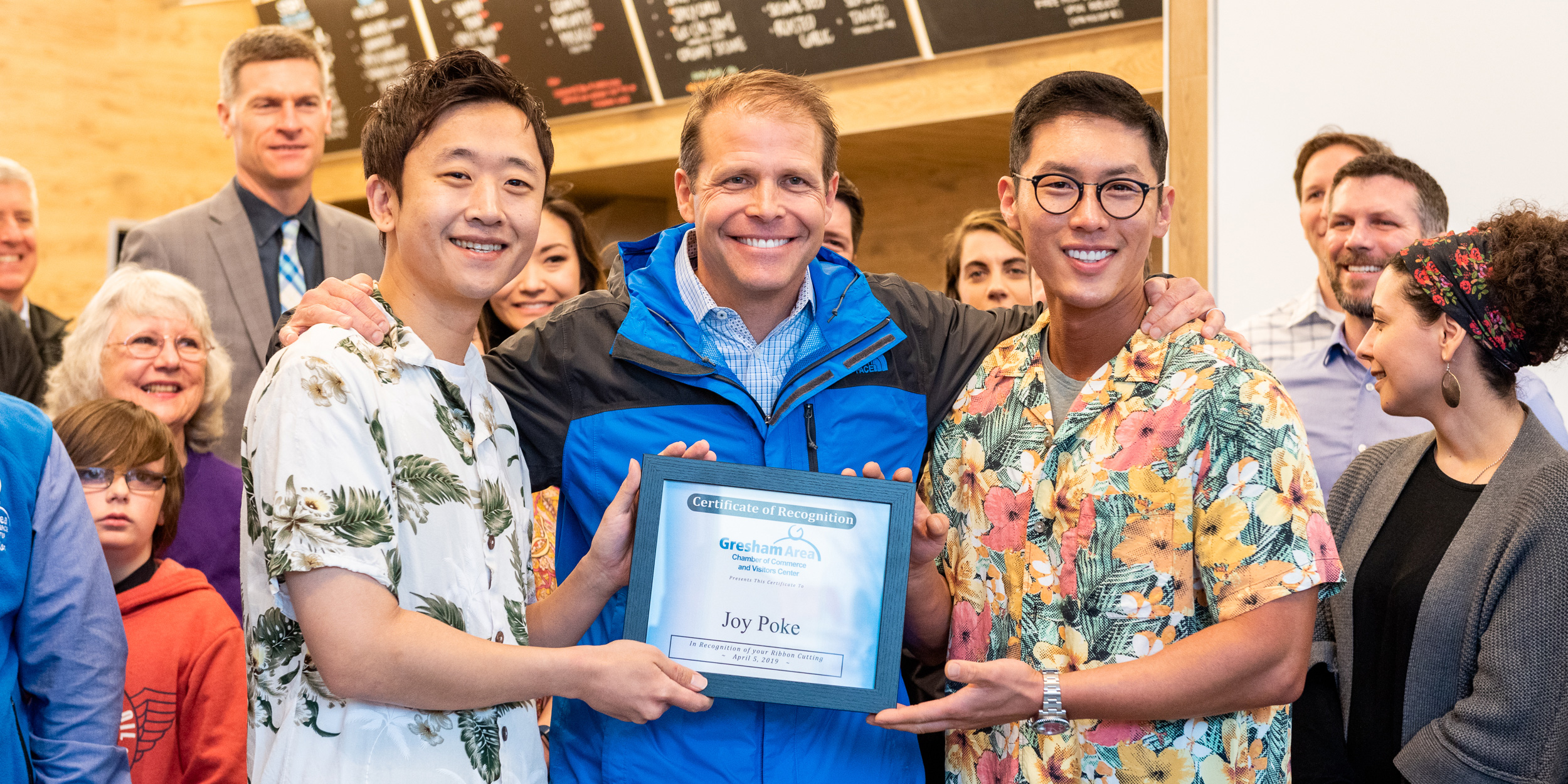 Joy Poke owner Justin, and partner Shaun, pose with the mayor of Troutdale, Casey Ryan