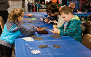 Kids making crafts at Gresham Station event